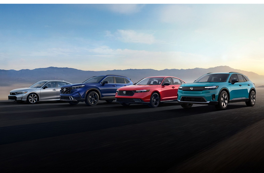 Honda's line-up of hybrid and electric vehicles: Civic Sedan Hybrid, CR-V Sport Touring Hybrid, Accord Hybrid and All Electric Prologue lined up on the road.