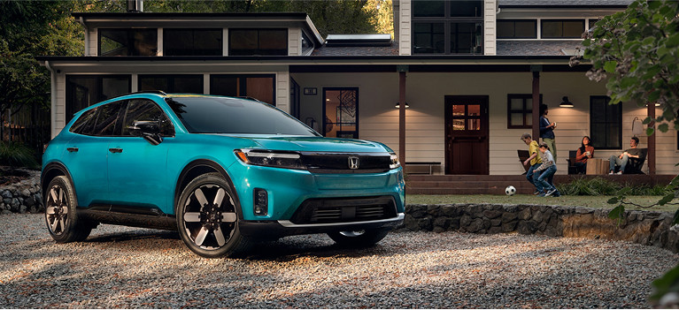 2024 Honda Prologue parked in front of a surburban home with kids playing outside