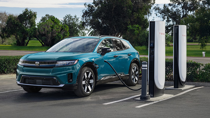 2025 Honda Prologue in North Shore Pearl charging in a Tesla Super Charger