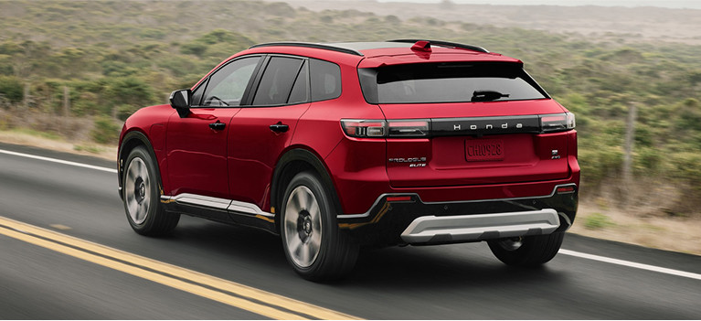 2024 Certified Honda Prologue in red driving along a road