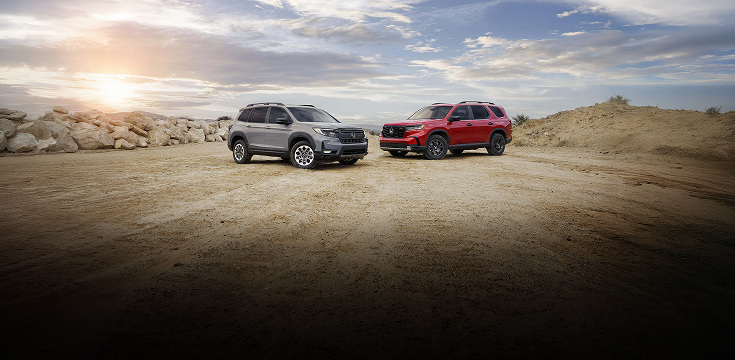 2025 Honda Passport and Honda Pilot front parked on rocky terrain with a cloudy sky background. 2025 Honda Passport and Honda Pilot front parked on rocky terrain with a cloudy sky background.