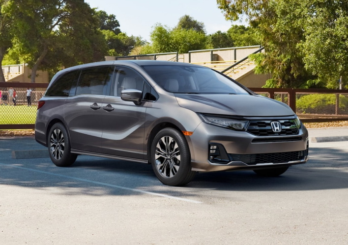 Honda Oddysey parked by a school sport field